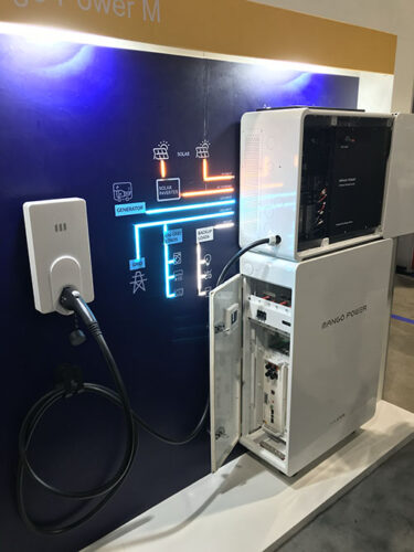 An electric vehicle charger cable is strung to a home energy storage unit. 